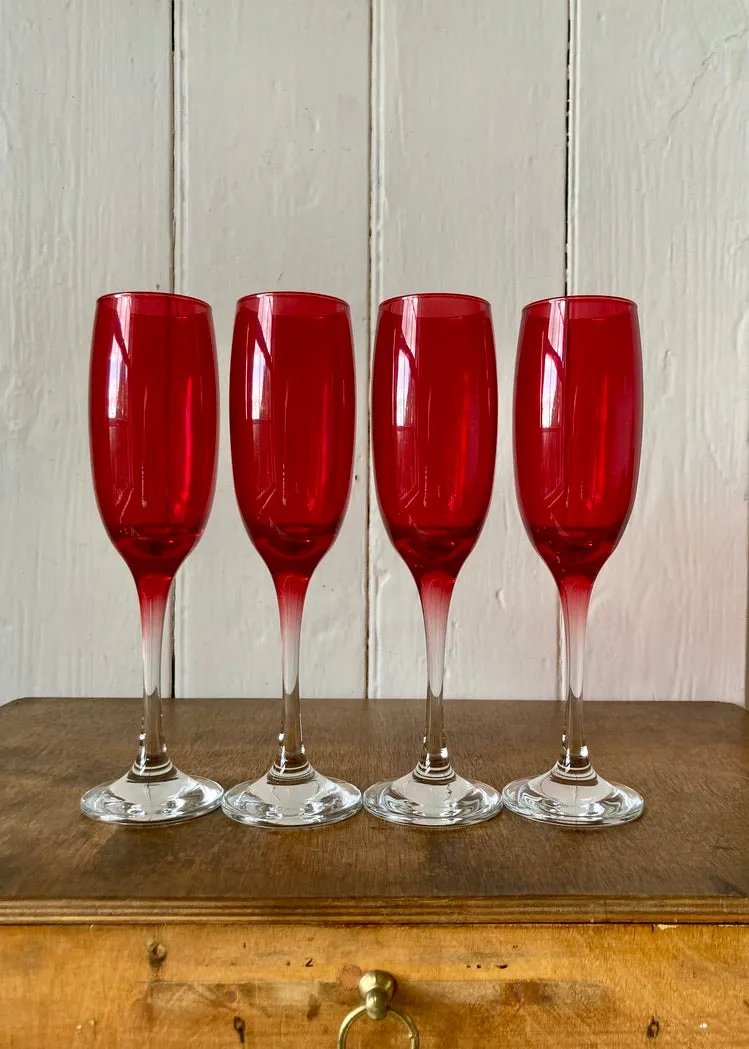 A set of 4 vintage cranberry glass champagne flutes